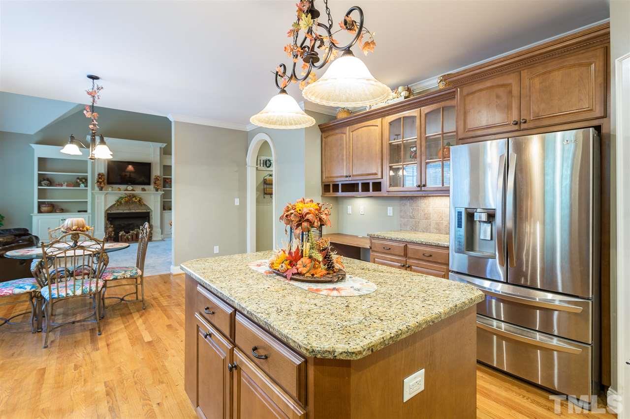 12 Vista Ridge Drive Willow Spring, NC 27592 - Photo 13 of 30 This gourmet island kitchen is a chef's delight & boasts granite counter-tops, tile backsplash & hdwd floors. The stainless steel appliance package includes a built-in microwave, dishwasher, smooth-top electric range w/self-cleaning oven & a refrigerator.