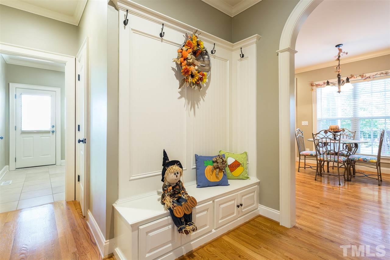 12 Vista Ridge Drive Willow Spring, NC 27592 - Photo 14 of 30 This lovely mud room is conveniently located near the garage, half bath and the laundry room. Room features bench seating with cabinet storage beneath and hooks for hanging jackets or backpacks. Note the arched entry to the kitchen and breakfast room.