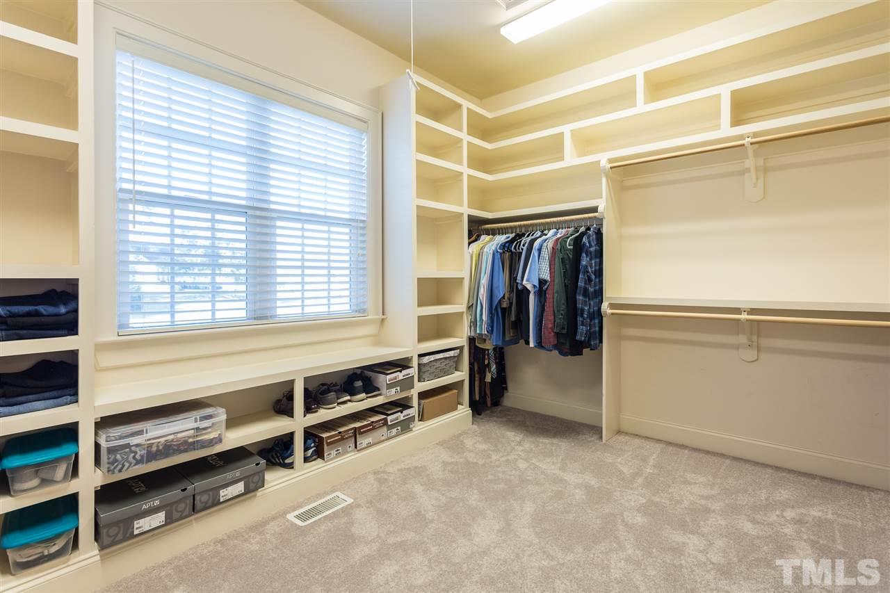 12 Vista Ridge Drive Willow Spring, NC 27592 - Photo 19 of 30 This generous master closet is located just off the master bath and features new carpet and lots of custom shelving. Double windows provide plenty of natural lighting. The pull-down stairs to the attic is conveniently located in this closet.