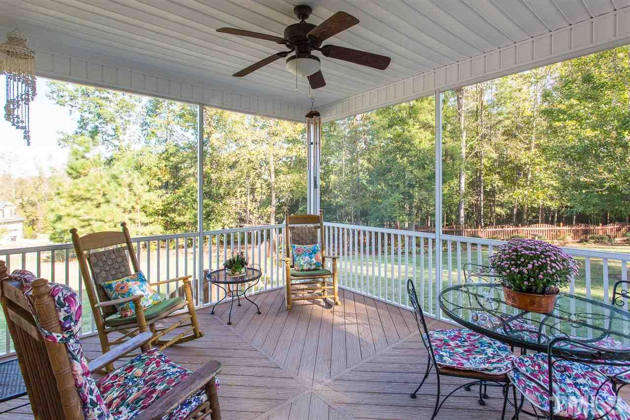 12 Vista Ridge Drive Willow Spring, NC 27592 - Photo 25 of 30 Relax after a long day's work on this cozy screened-in porch overlooking your spacious back yard. Room boasts a ceiling fan for added convenience and comfort.