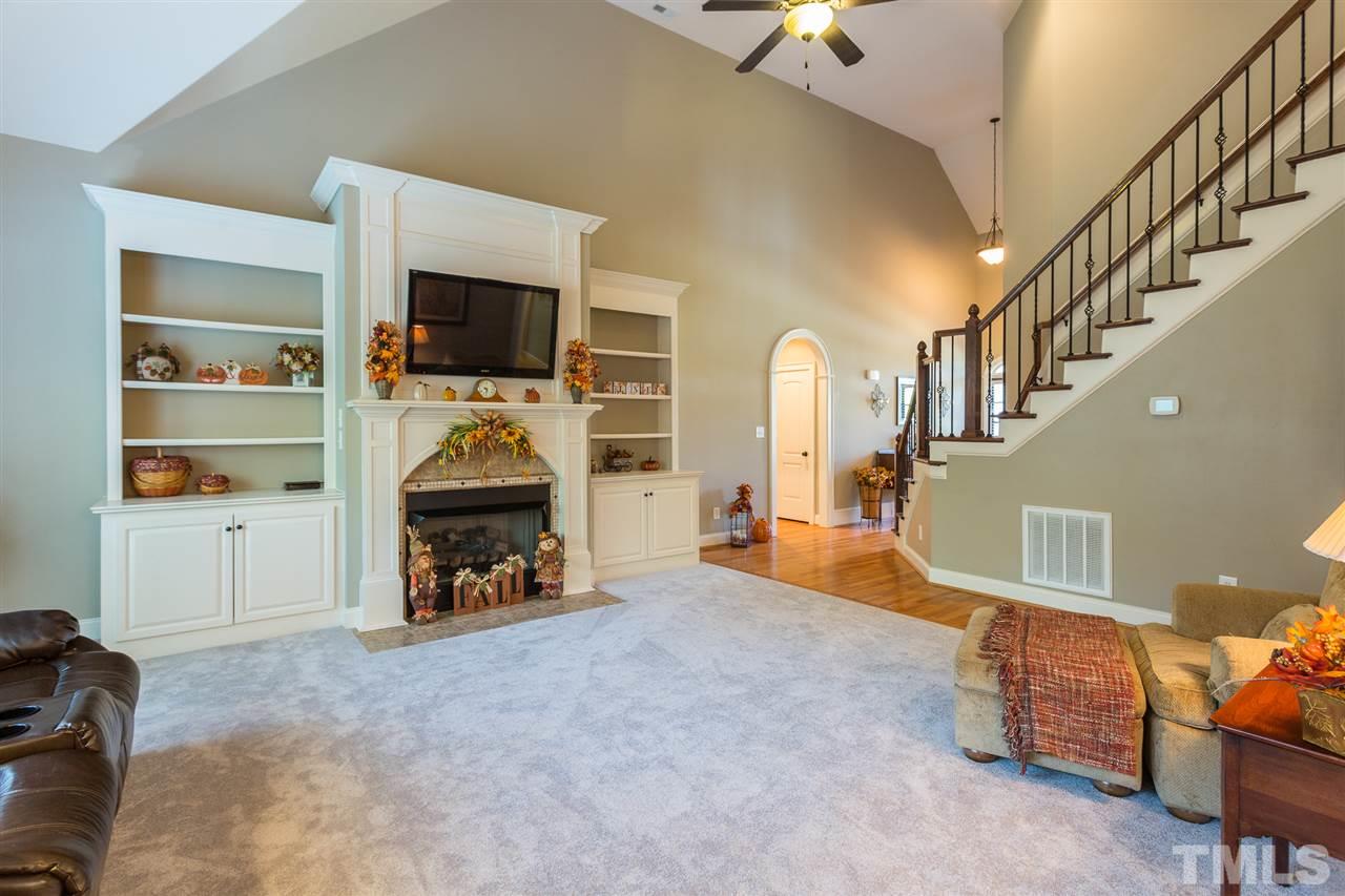 12 Vista Ridge Drive Willow Spring, NC 27592 - Photo 8 of 30 The gas log fireplace which is graced by beautiful built-in shelving is the focal point of this generous family room. Room boasts new carpet for your enjoyment.