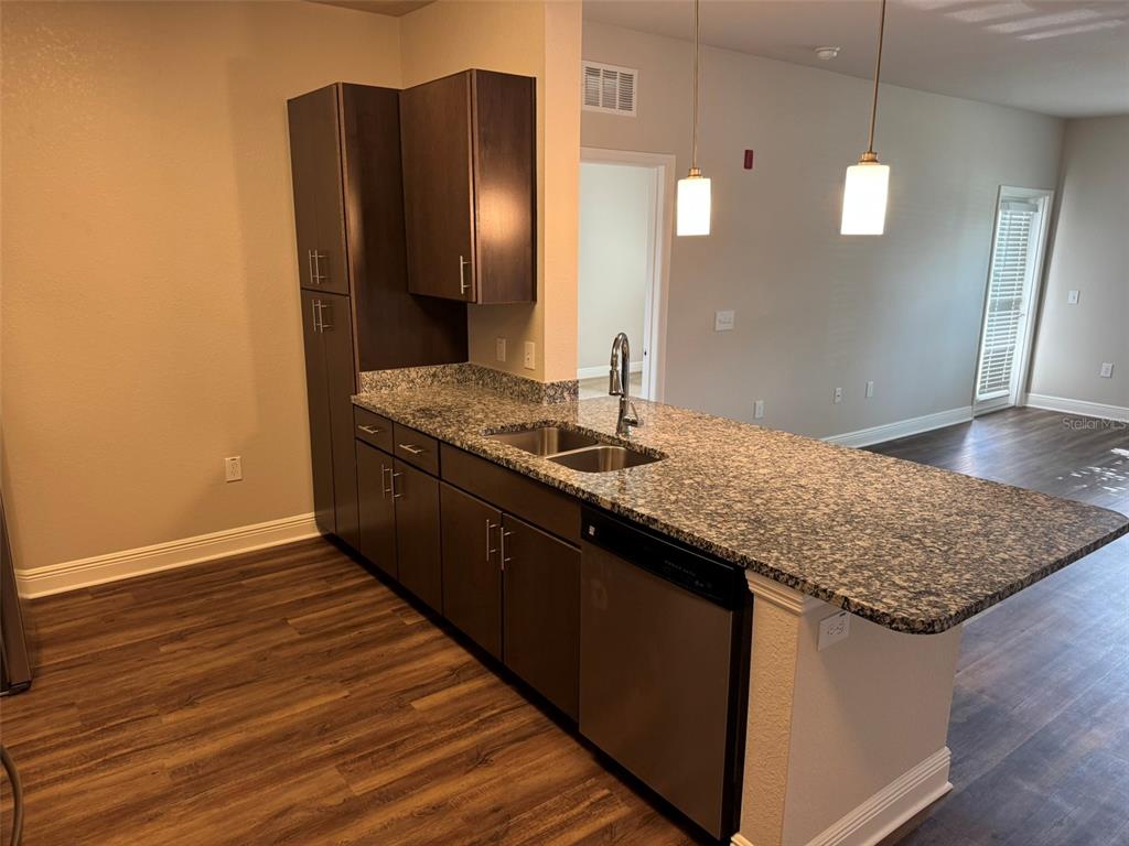 2460 Ann Rou Road, Unit 606 Tavares, FL 32778 - Photo 4 of 18 a bathroom with a granite countertop sink and a mirror