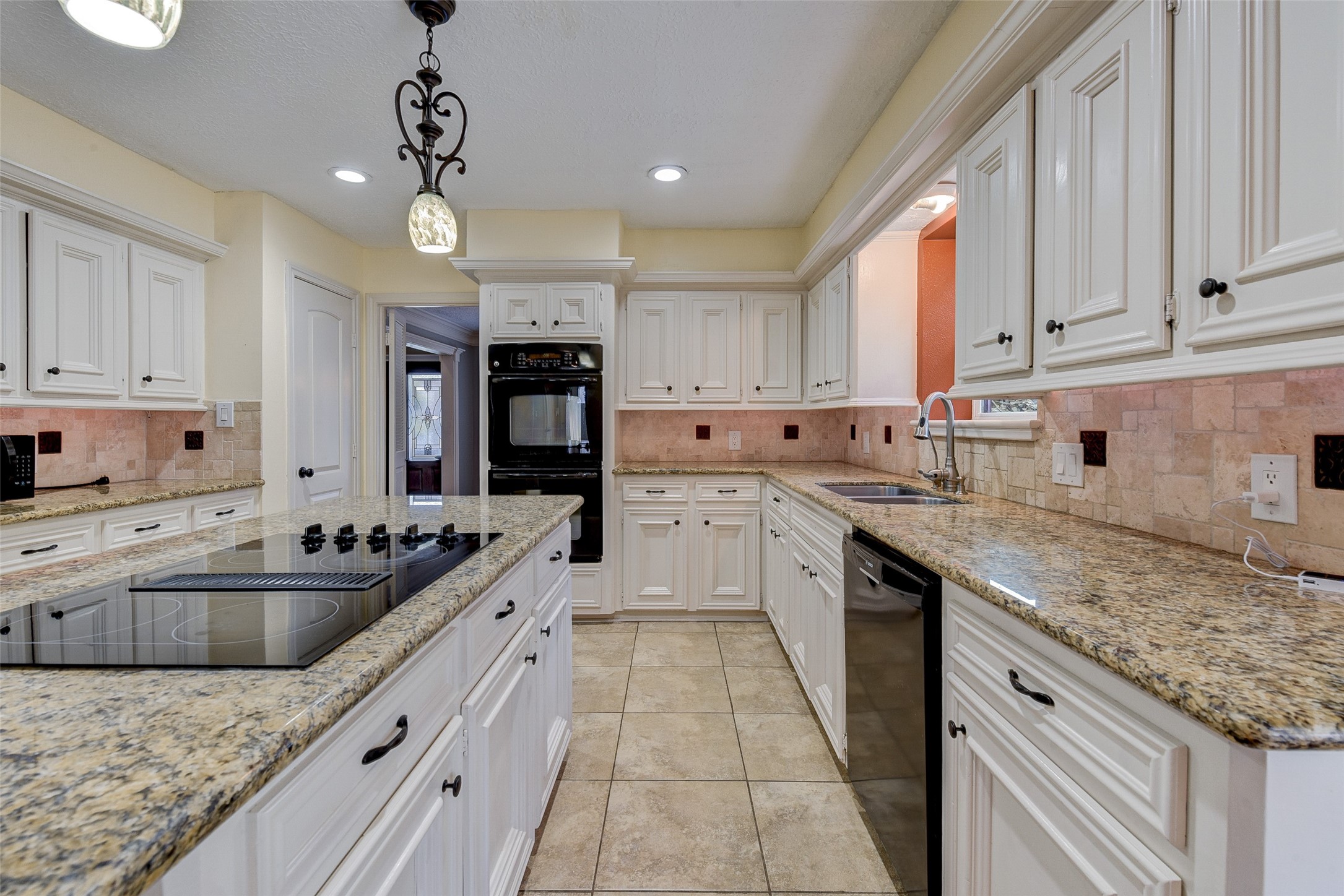 18310 Lake Oaks Drive Spring, TX 77388 - Photo 13 of 31 a kitchen with kitchen island granite countertop a sink a counter space appliances and cabinets