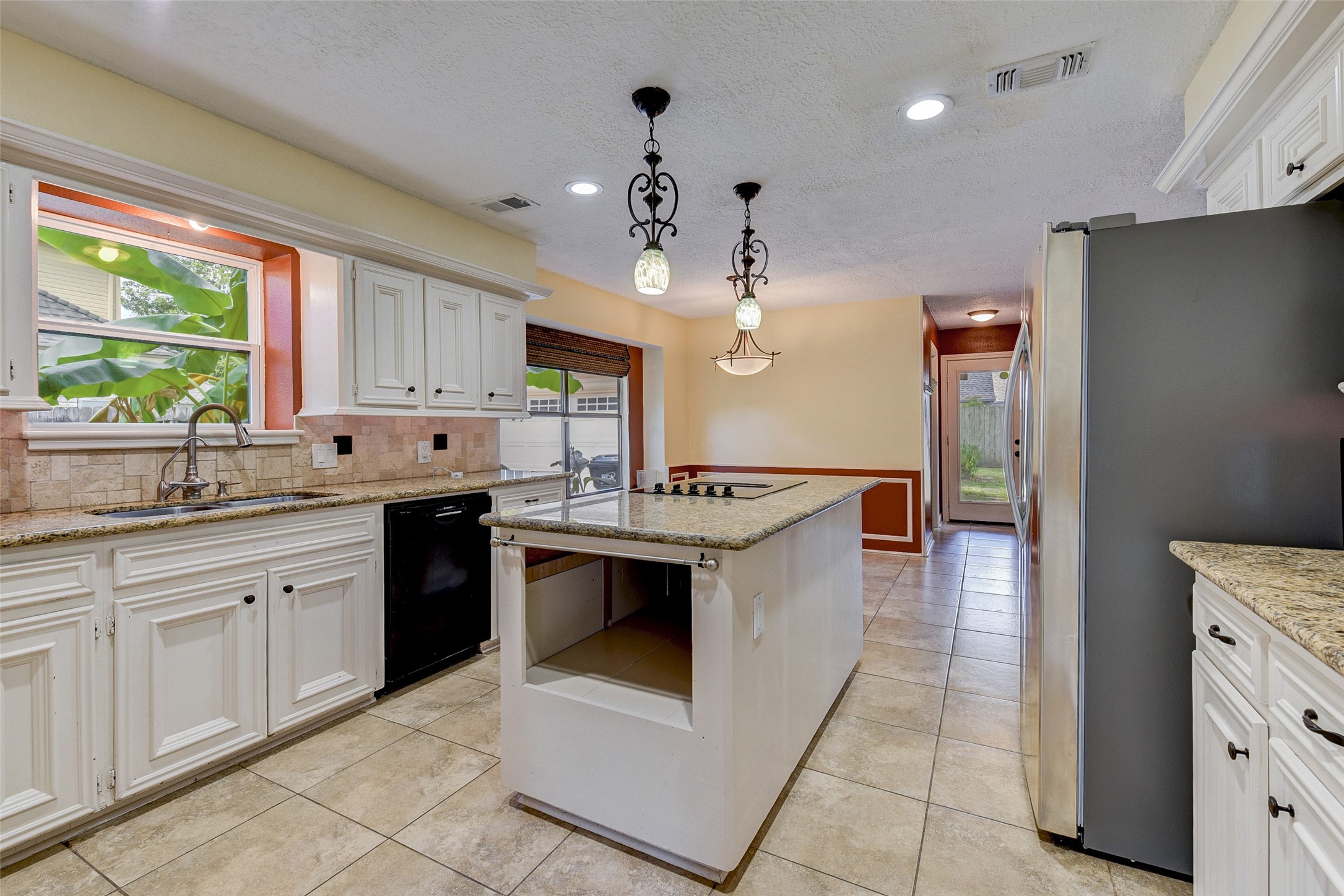 18310 Lake Oaks Drive Spring, TX 77388 - Photo 14 of 31 a kitchen with stainless steel appliances granite countertop a sink a stove and a refrigerator