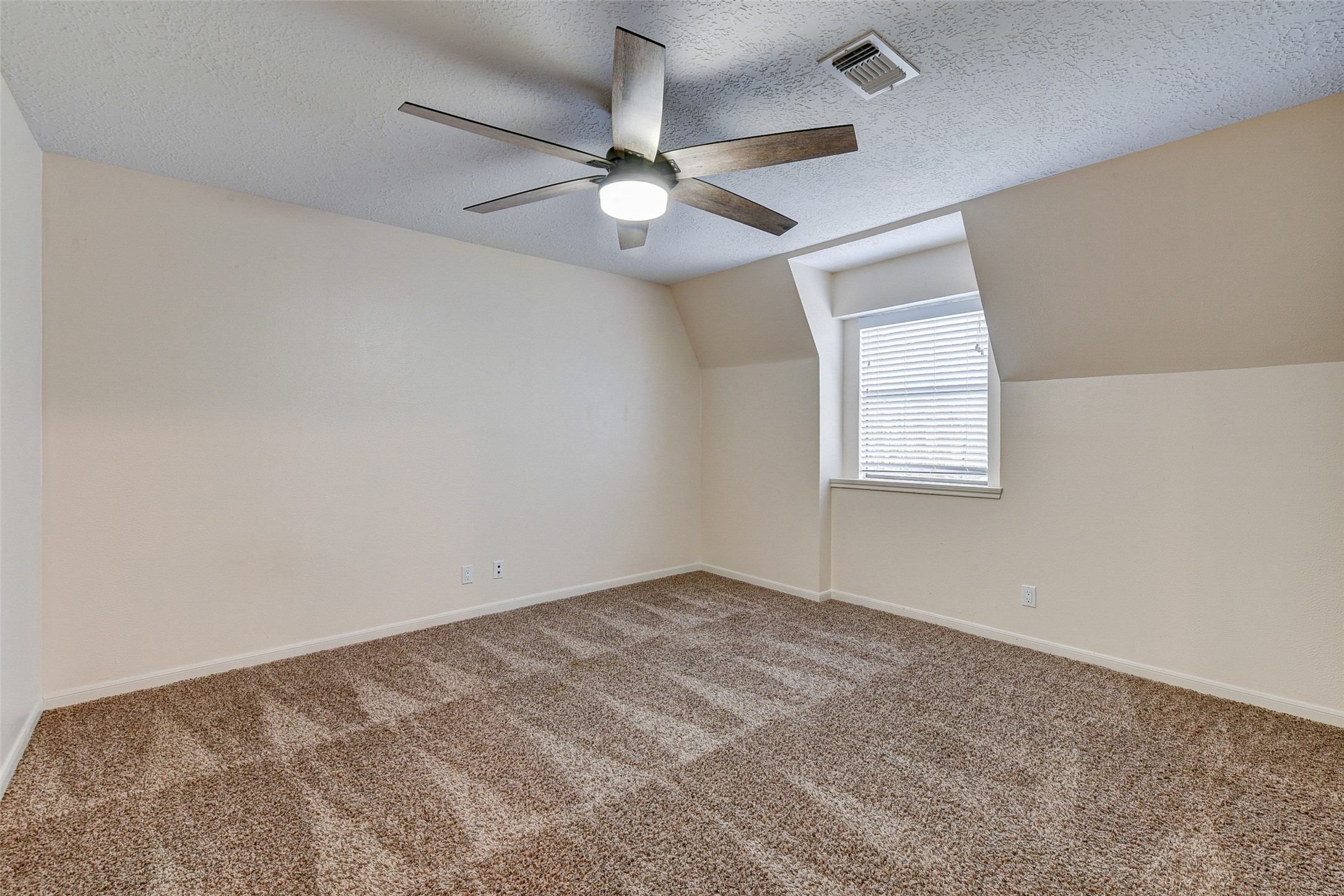 18310 Lake Oaks Drive Spring, TX 77388 - Photo 23 of 31 an empty room with windows and fan
