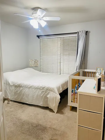 a bathroom with a sink a toilet and a shower curtain