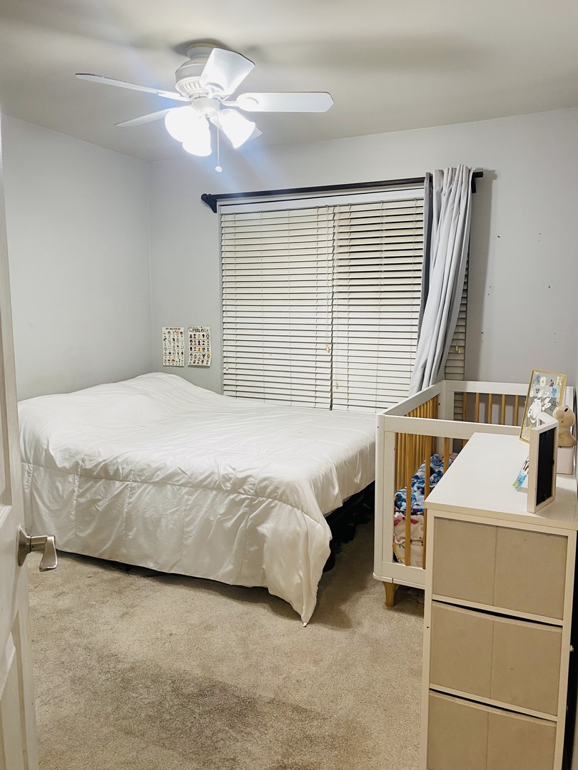 2745 Borkshire Lane, Unit 2745 Aurora, IL 60502 - Photo 14 of 23 a bedroom with a bed and a dresser