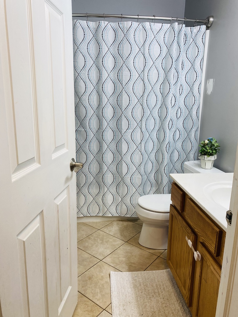 2745 Borkshire Lane, Unit 2745 Aurora, IL 60502 - Photo 15 of 23 a bathroom with a sink a toilet and a shower curtain