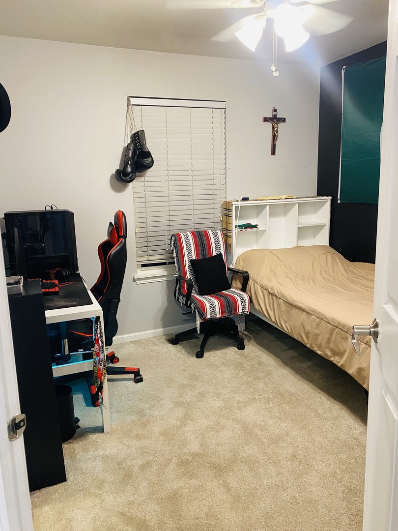 2745 Borkshire Lane, Unit 2745 Aurora, IL 60502 - Photo 16 of 23 a bedroom with bed and a chandelier