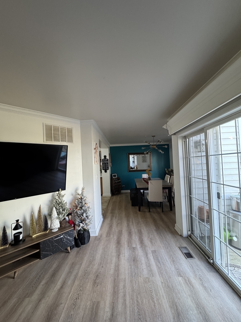 2745 Borkshire Lane, Unit 2745 Aurora, IL 60502 - Photo 18 of 23 a living room with furniture and a flat screen tv