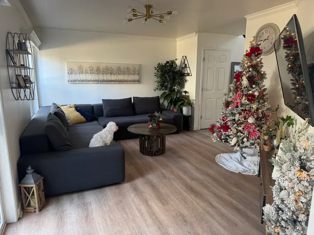 a view of a dining room with furniture a rug and wooden floor