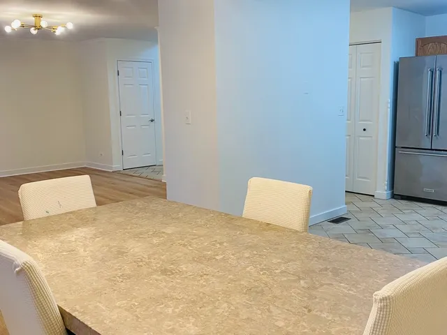 a bedroom with a bed and a refrigerator