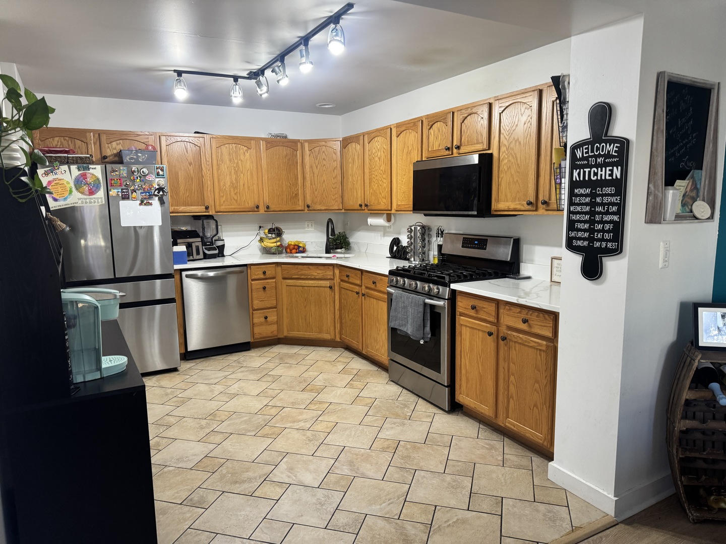 2745 Borkshire Lane, Unit 2745 Aurora, IL 60502 - Photo 7 of 23 a kitchen with stainless steel appliances granite countertop a refrigerator stove top oven and sink