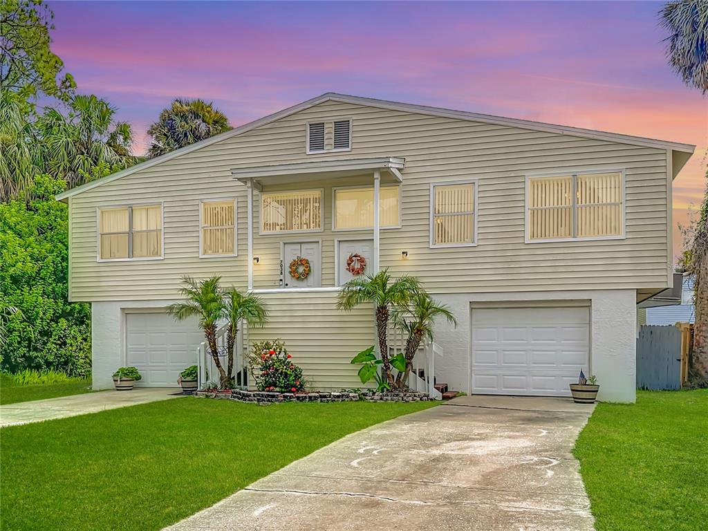 7036 Oelsner Street New Port Richey, FL 34652 - Photo 1 of 1 a front view of a house with a garden