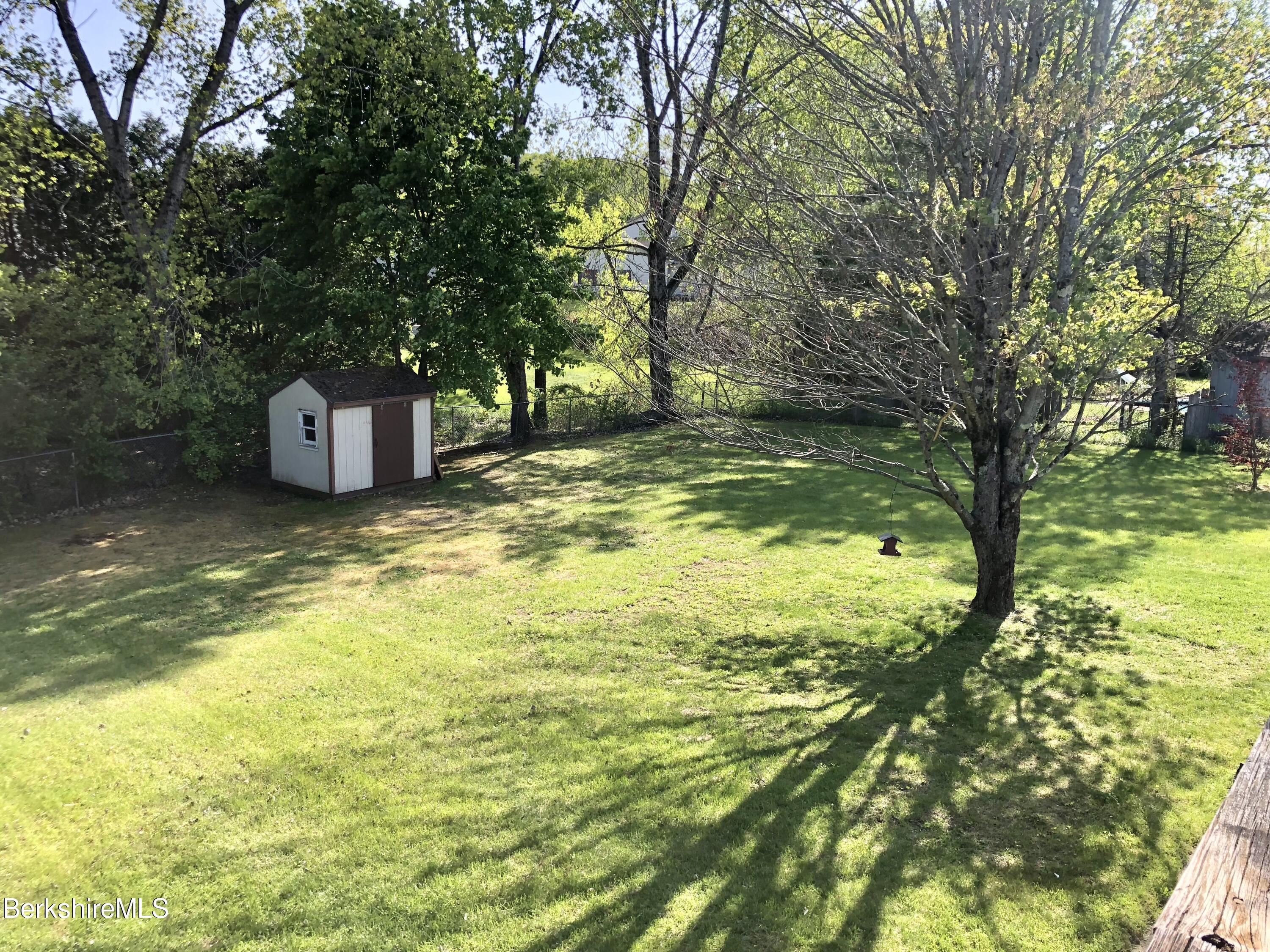 95 Bruce Drive Dalton, MA 01226 - Photo 30 of 30 a view of a pool with lawn chairs and a large tree