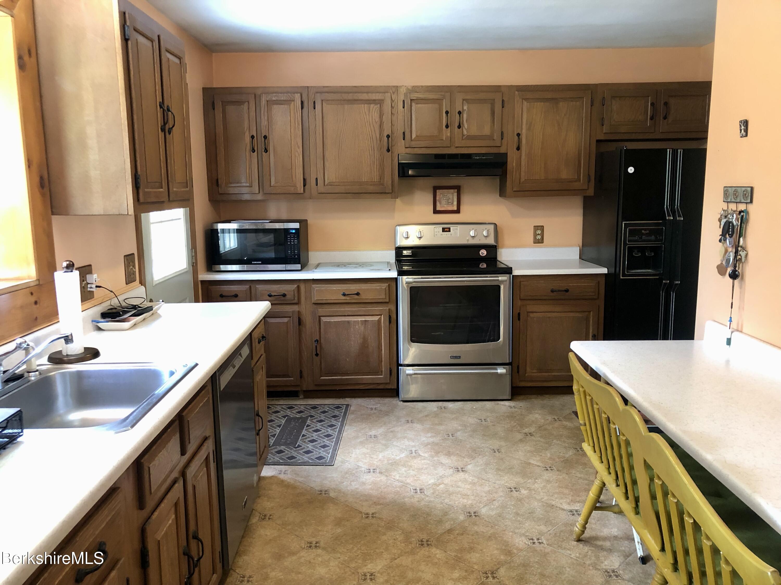 95 Bruce Drive Dalton, MA 01226 - Photo 9 of 30 a kitchen with a sink a stove and cabinets