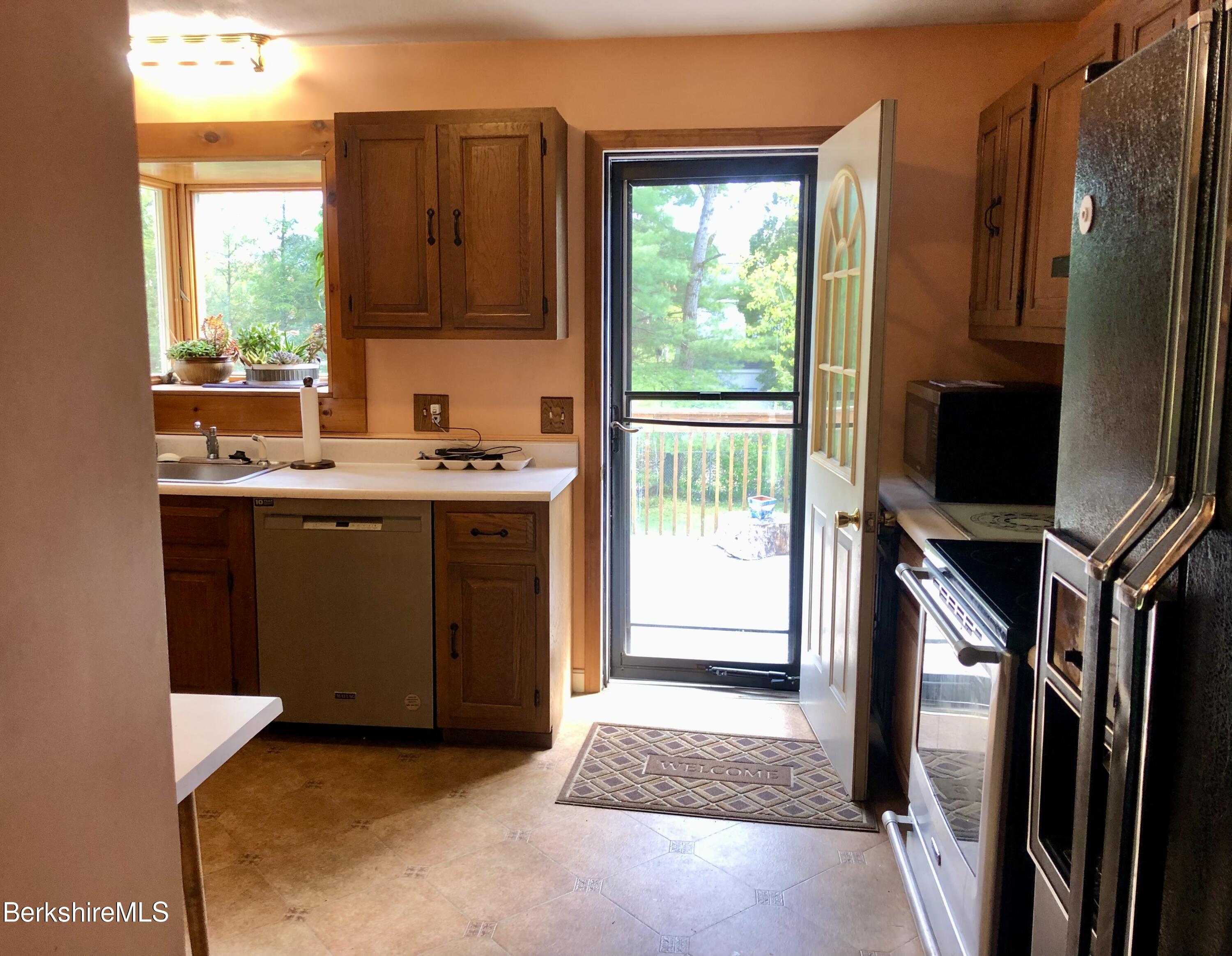 95 Bruce Drive Dalton, MA 01226 - Photo 10 of 30 a kitchen with stainless steel appliances granite countertop a stove a sink and a refrigerator