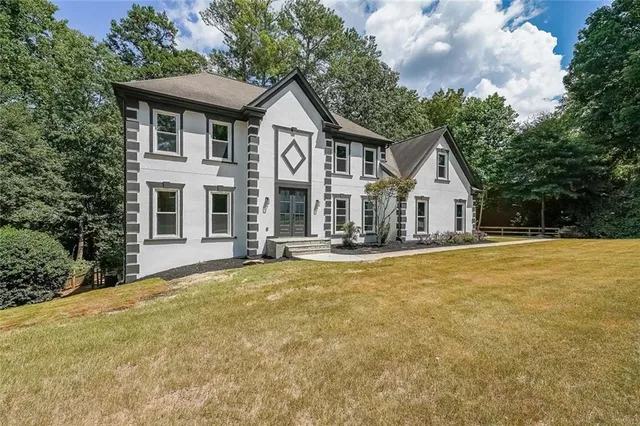 a view of house with outdoor space and sitting area