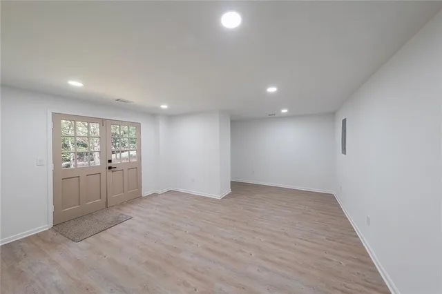 an empty room with windows and entrance