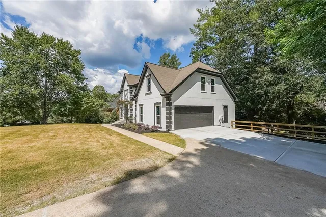 a front view of a house with a garden