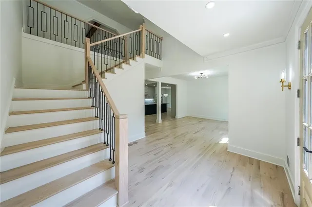 a view of entryway and hall with wooden floor