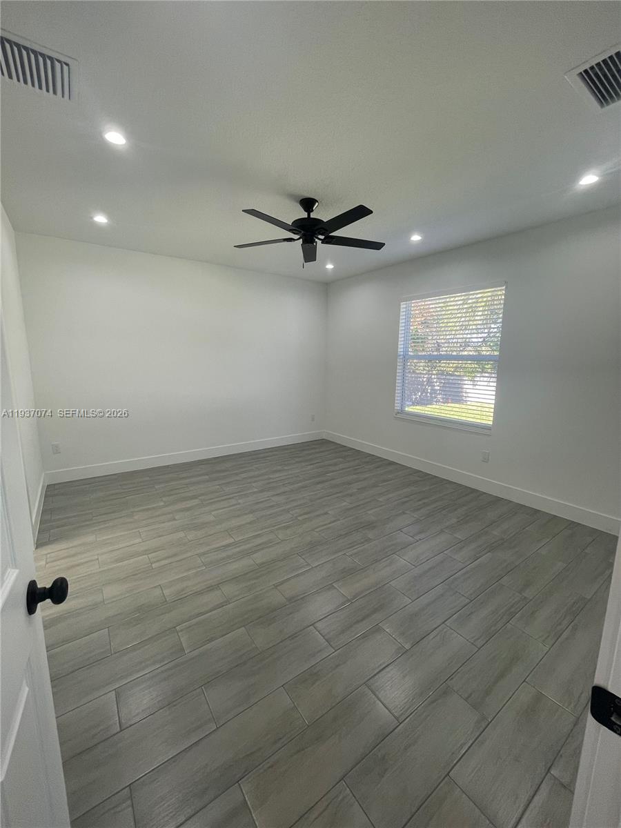 912 West 10th Street Riviera Beach, FL 33404 - Photo 18 of 24 an empty room with windows and fan
