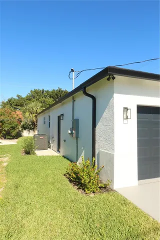 a view of a house with backyard and swimming pool