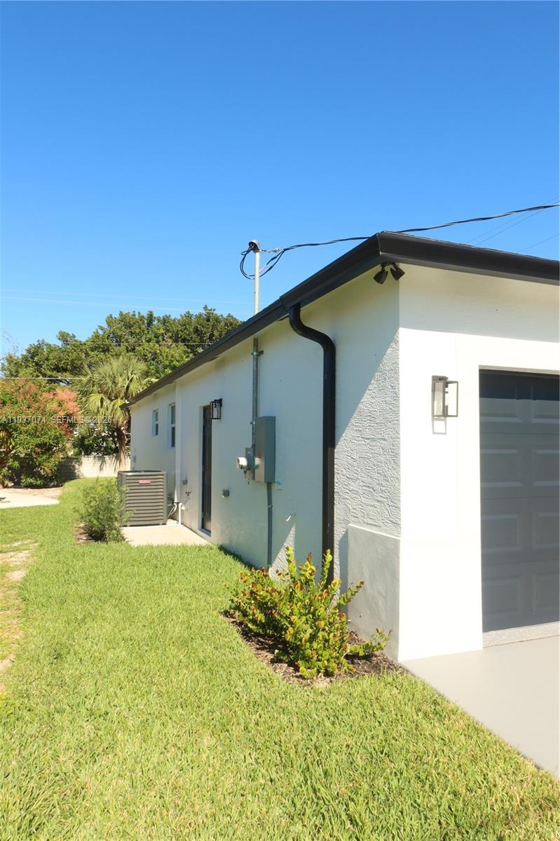 912 West 10th Street Riviera Beach, FL 33404 - Photo 22 of 24 a house with a yard