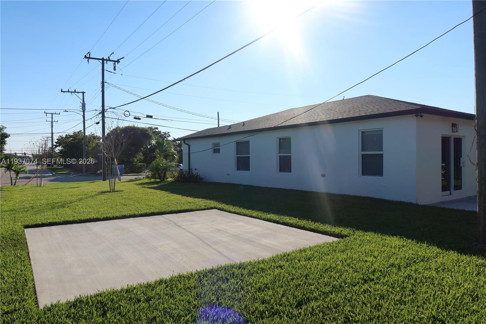 912 West 10th Street Riviera Beach, FL 33404 - Photo 4 of 24 a front view of a house with a yard and garage