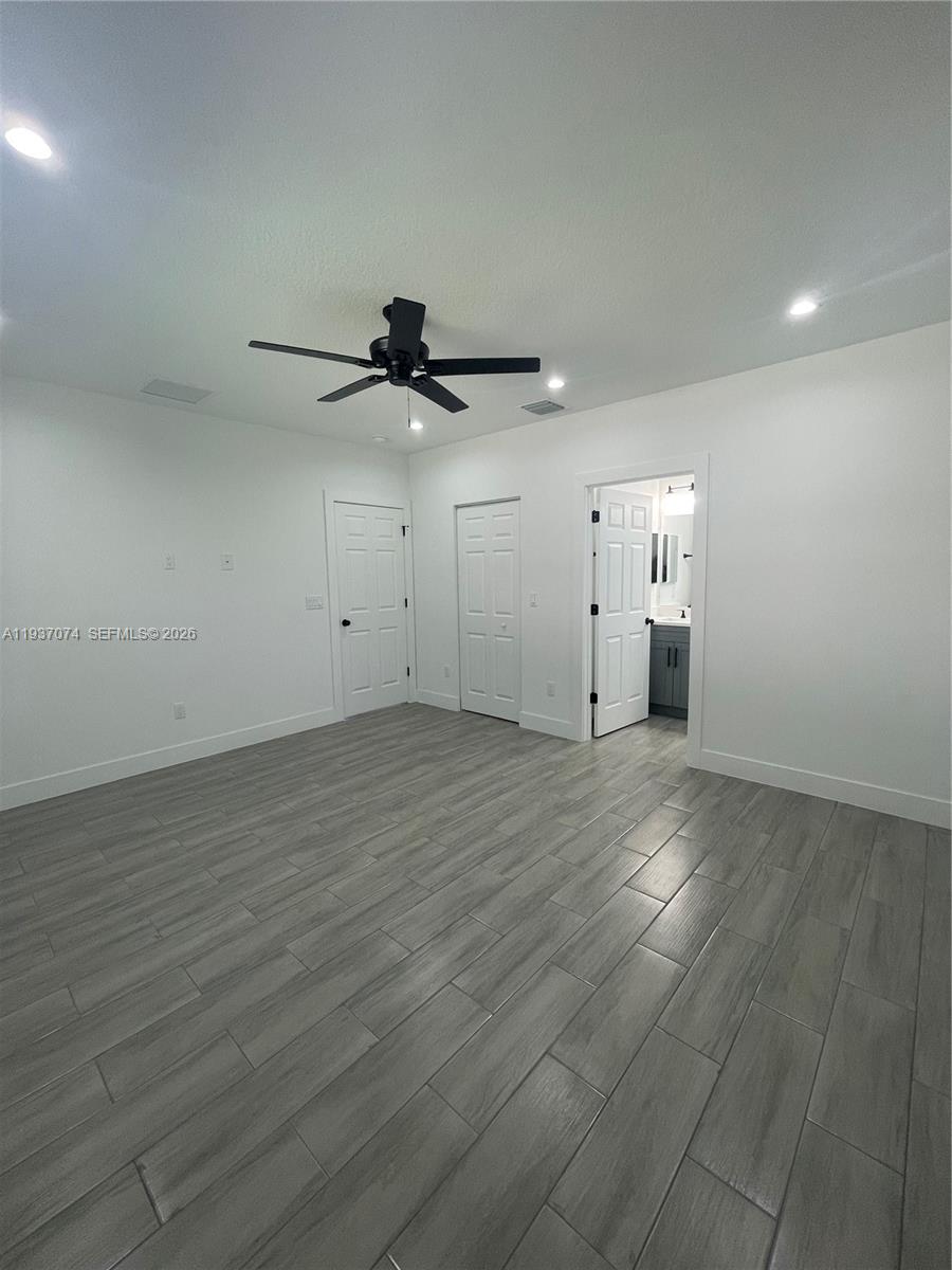 912 West 10th Street Riviera Beach, FL 33404 - Photo 8 of 24 an empty room with a empty space and a ceiling fan