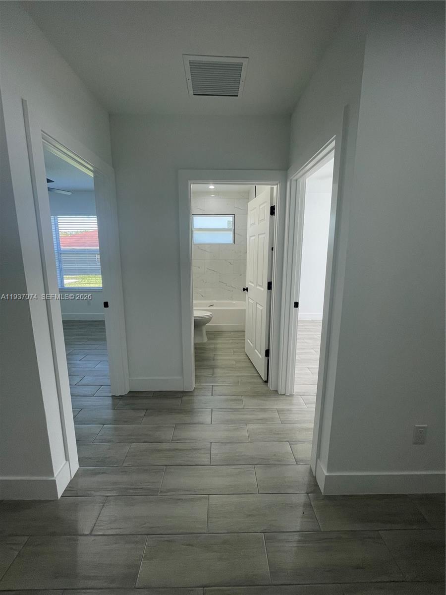 912 West 10th Street Riviera Beach, FL 33404 - Photo 9 of 24 a view of a hallway with wooden floor