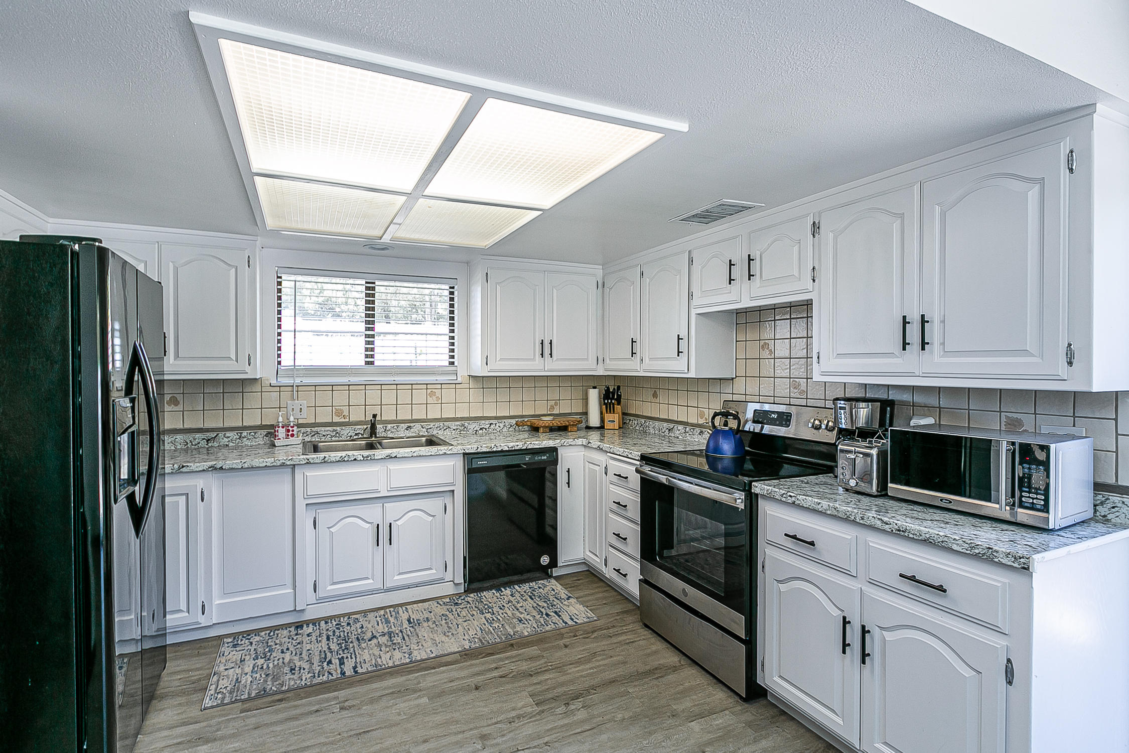 5375 Campbell Road Lompoc, CA 93436 - Photo 15 of 48 a kitchen with granite countertop cabinets stainless steel appliances and a window
