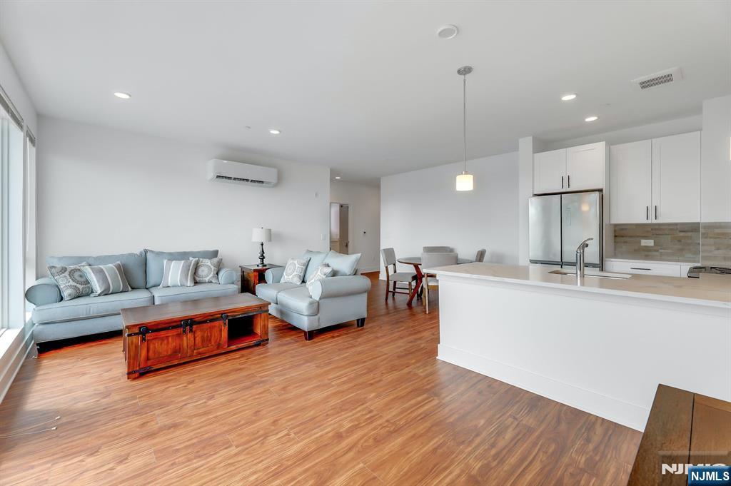 85 Ridge Road, Unit 111 North Arlington, NJ 07031 - Photo 13 of 27 a living room with furniture and a wooden floor