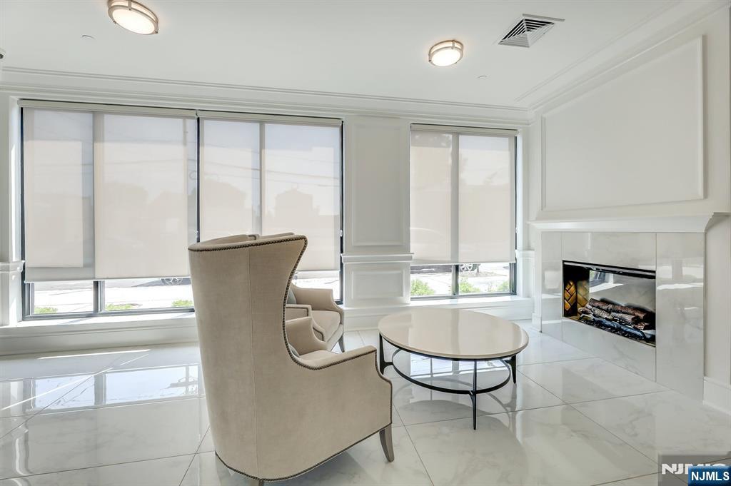 85 Ridge Road, Unit 111 North Arlington, NJ 07031 - Photo 4 of 27 a view of a livingroom with furniture and a fireplace