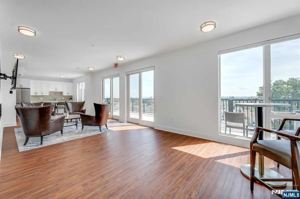 85 Ridge Road, Unit 111 North Arlington, NJ 07031 - Photo 5 of 27 a view of a dining room with furniture window and wooden floor