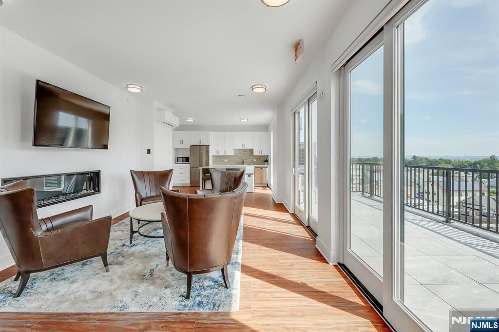 85 Ridge Road, Unit 111 North Arlington, NJ 07031 - Photo 6 of 27 a living room with a couch and a flat screen tv