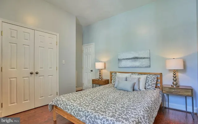 a bedroom with a bed and a lamp