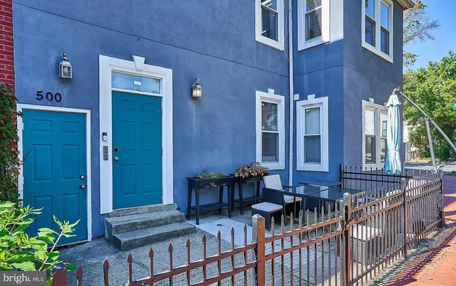 a view of a house with large windows and furniture