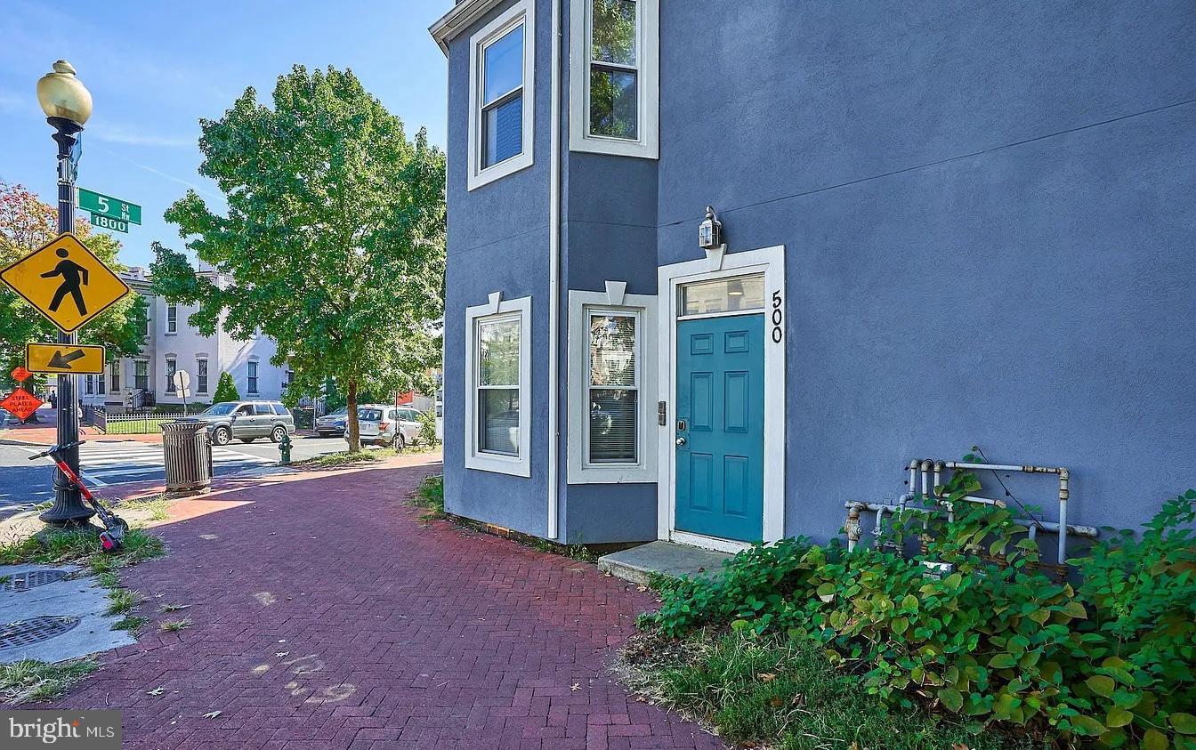 500 Florida Avenue Northwest, Unit 1 Washington, DC 20001 - Photo 18 of 20 a view of a brick wall with a small yard and large trees