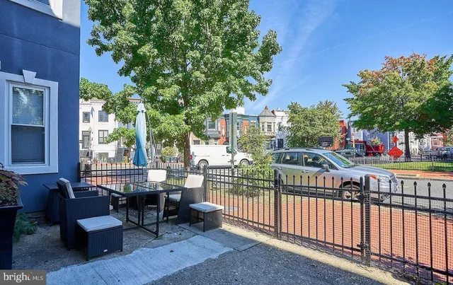 a view of a building with a bench in patio