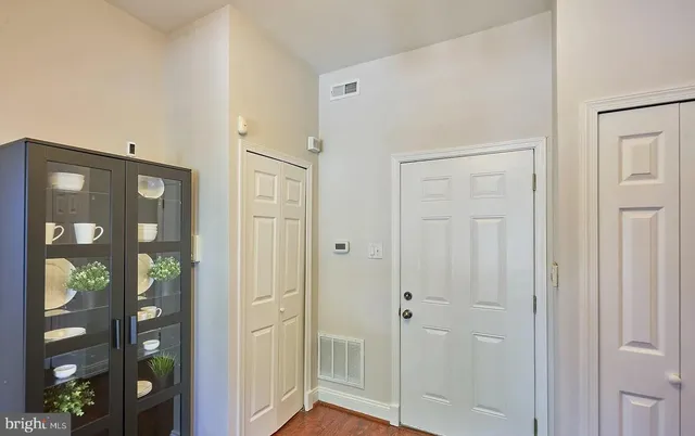 a bathroom with a glass shower door and a window
