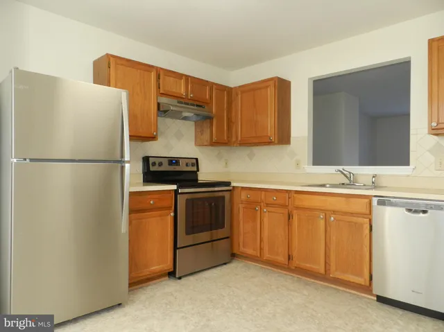 a white refrigerator freezer sitting in a kitchen