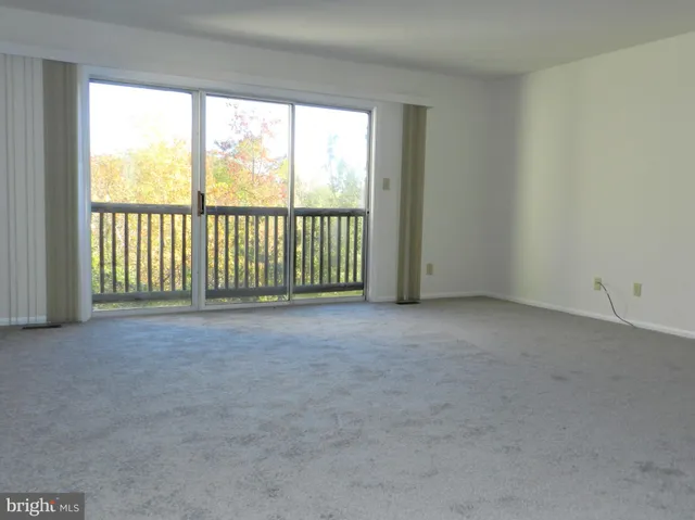a view of an empty room with a balcony