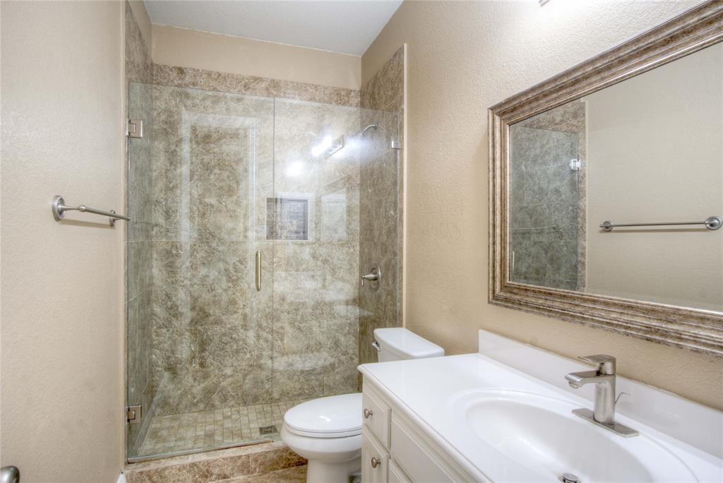 1122 Bridgeway Lane Allen, TX 75013 - Photo 15 of 22 a bathroom with a sink mirror toilet and shower