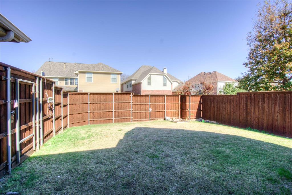 1122 Bridgeway Lane Allen, TX 75013 - Photo 21 of 22 a view of a house with a yard and wooden fence