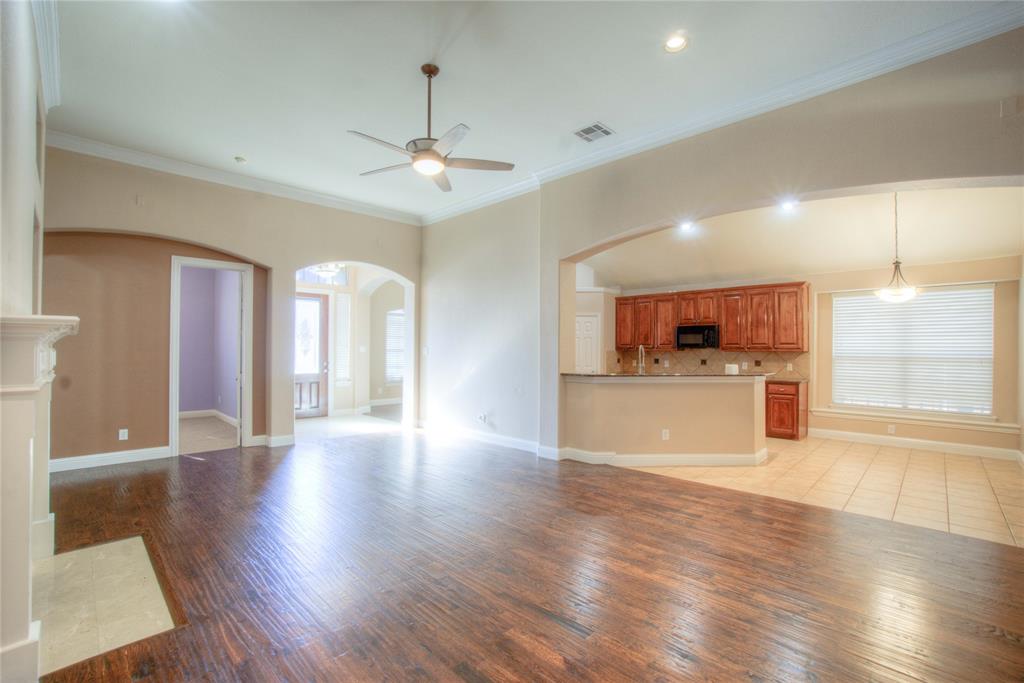 1122 Bridgeway Lane Allen, TX 75013 - Photo 4 of 22 a view of a kitchen with a sink cabinets and wooden floor