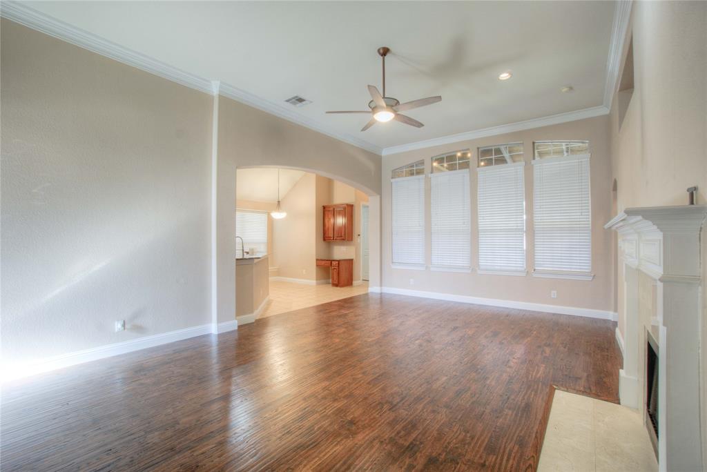 1122 Bridgeway Lane Allen, TX 75013 - Photo 5 of 22 a view of an empty room with wooden floor and a window