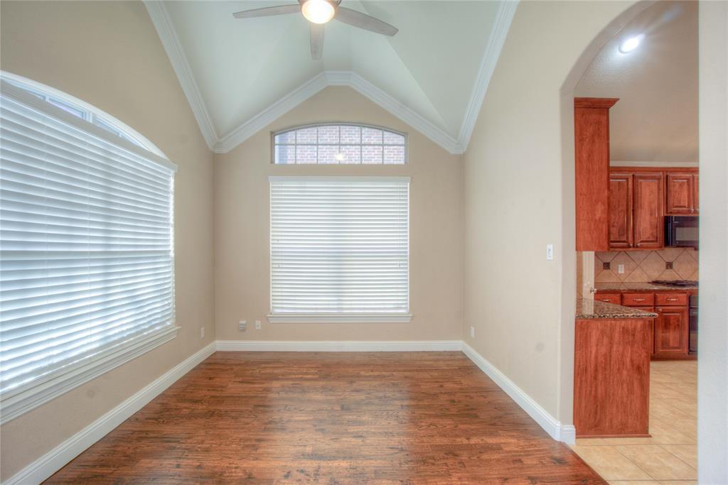 1122 Bridgeway Lane Allen, TX 75013 - Photo 6 of 22 an empty room with wooden floor cabinet and windows