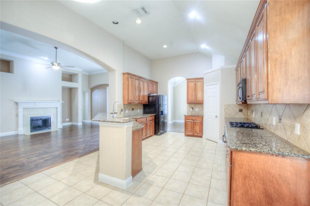 1122 Bridgeway Lane Allen, TX 75013 - Photo 22 of 22 a kitchen with stainless steel appliances granite countertop a stove top oven a sink a counter space and cabinets
