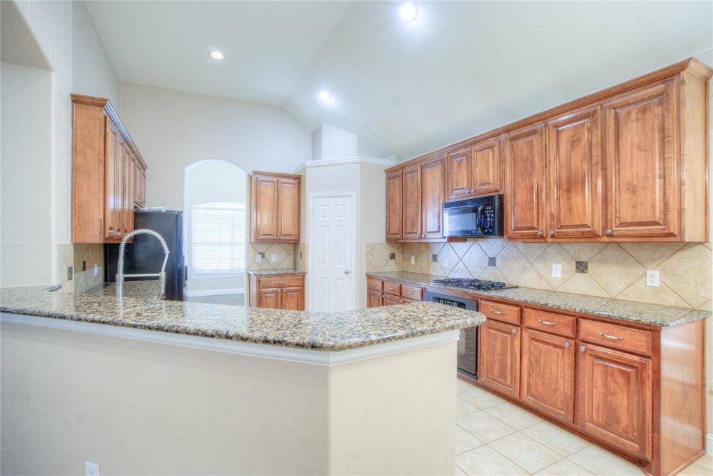 1122 Bridgeway Lane Allen, TX 75013 - Photo 9 of 22 a kitchen with stainless steel appliances granite countertop a sink dishwasher stove and cabinets with wooden floor